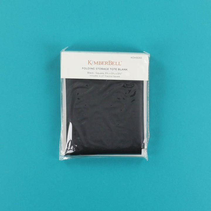 Packaged black Kimberbell folding storage tote on a teal background