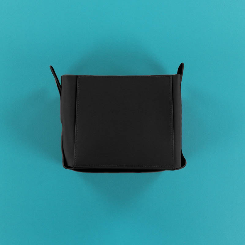 Black rectangular container on a teal background
