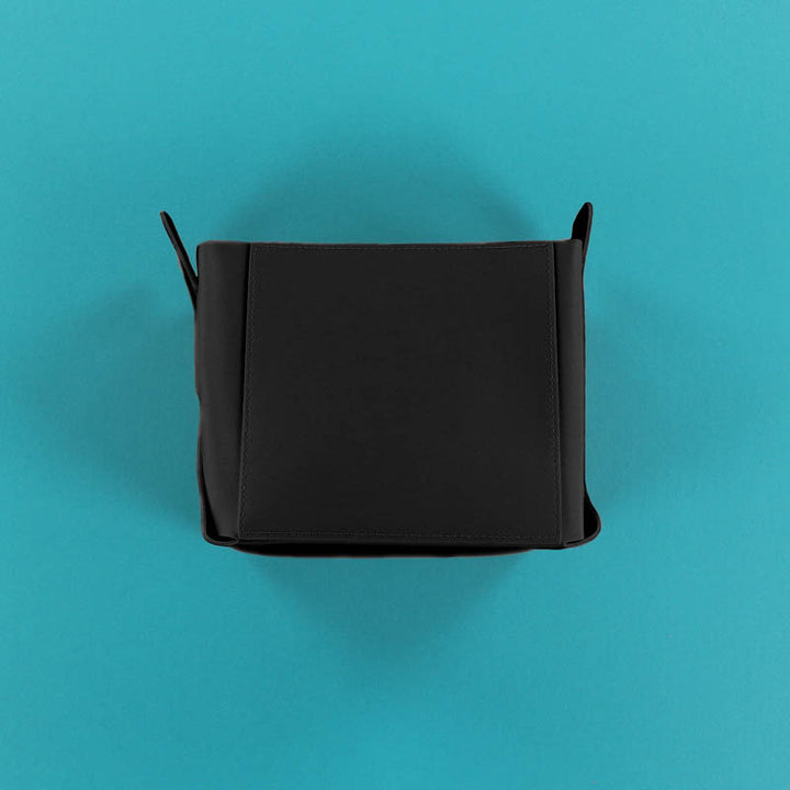 Black rectangular container on a teal background