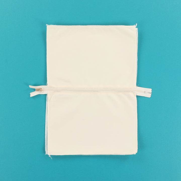 Beige fabric pouch with a zipper on a blue background