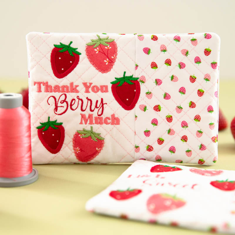 Mug rug with strawberry pattern and 'Thank you berry much' text.