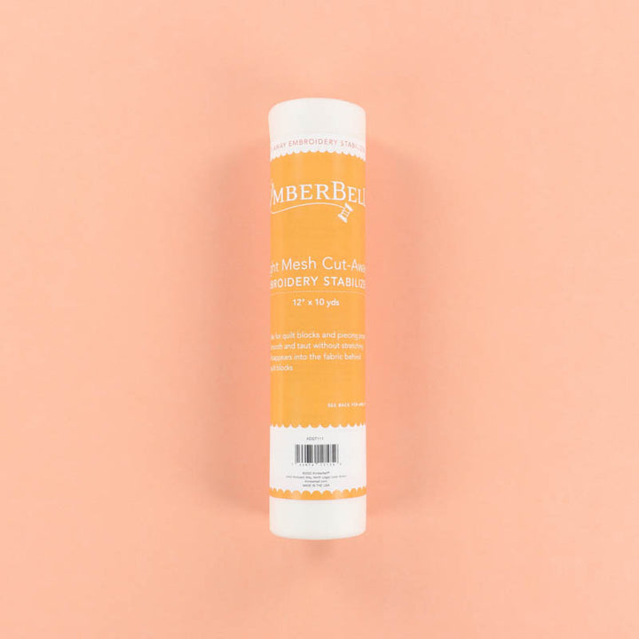 Roll of Light-Mesh Cut-Away Kimberbell embroidery stabilizer on a peach background