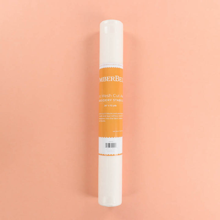 Roll of Light-Mesh Cut-Away stabilizer on a peach background