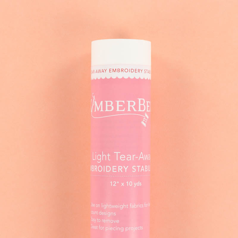 Roll of Light Tear-Away of Kimberbell tear-away embroidery stabilizer on a peach background