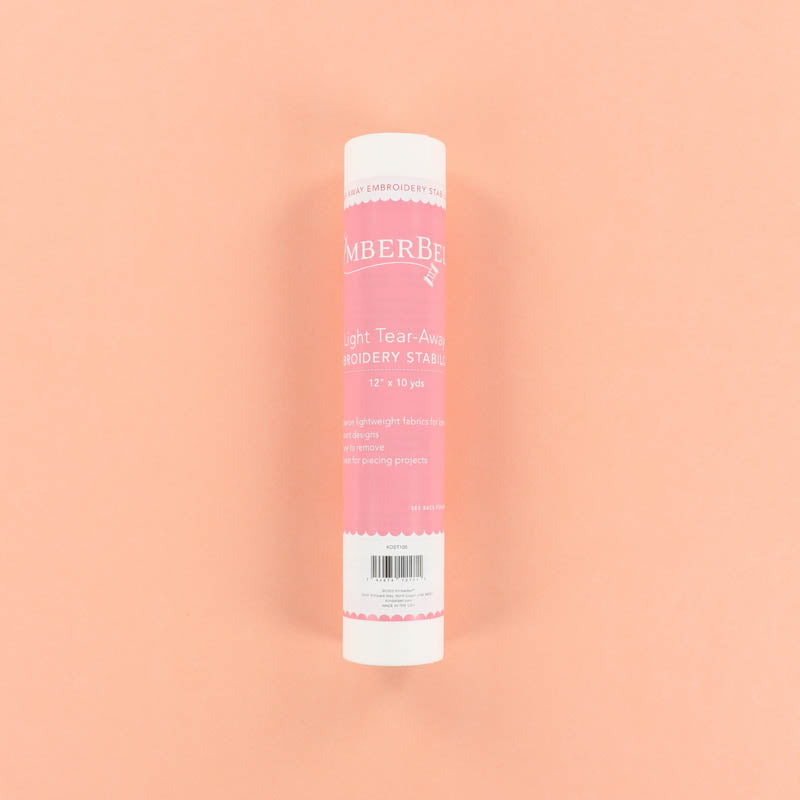 Roll of Light Tear-Away of Kimberbell tear-away embroidery stabilizer on a peach background