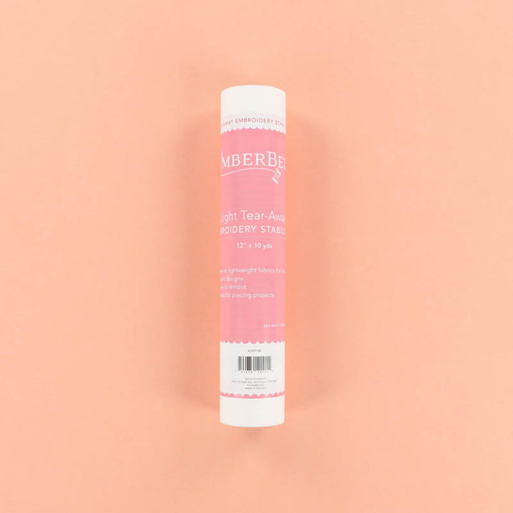 Roll of Light Tear-Away of Kimberbell tear-away embroidery stabilizer on a peach background