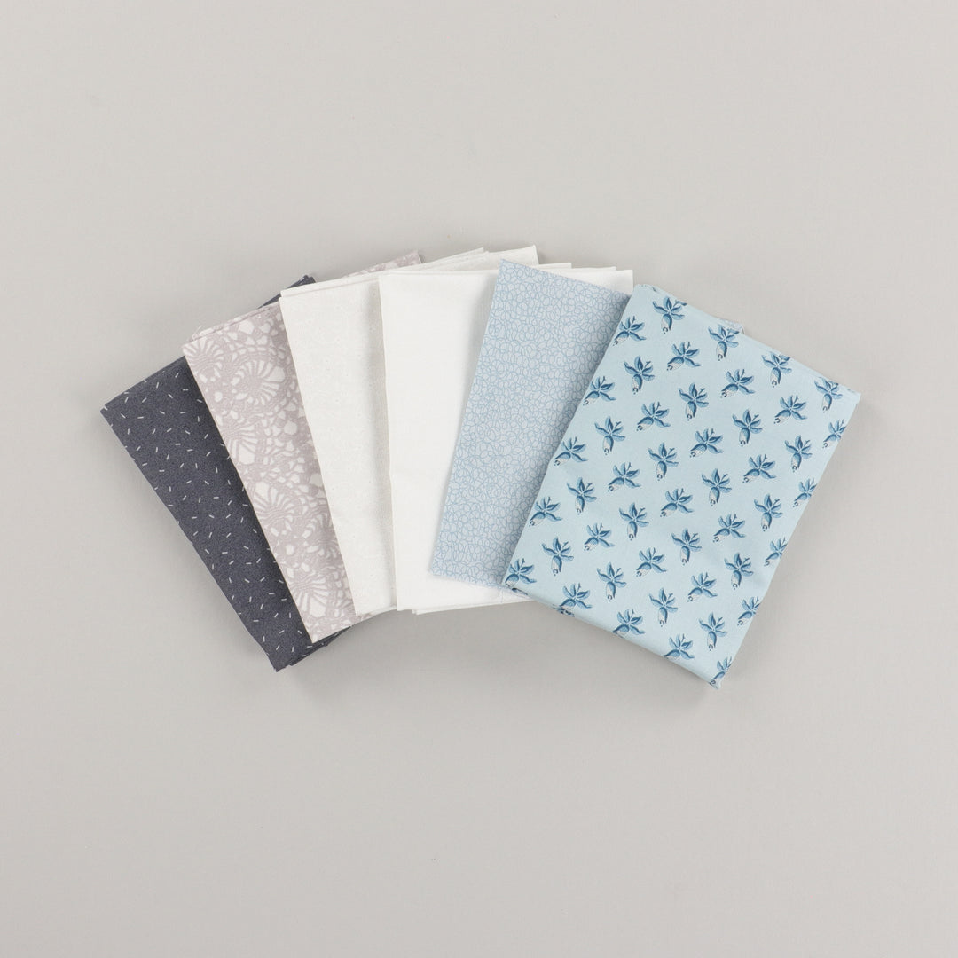 Set of fabric swatches with various patterns on a gray background