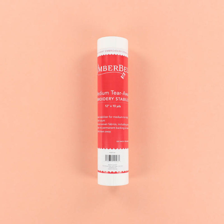 Roll of Kimberbell Medium Tear-Away embroidery stabilizer on a peach background