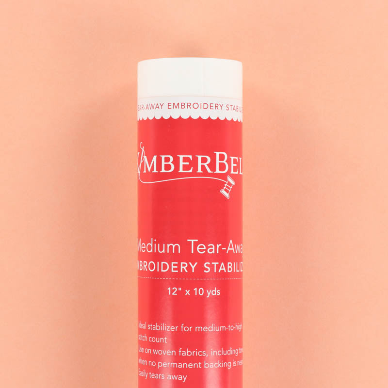 Roll of Kimberbell Medium Tear-Away embroidery stabilizer on a peach background