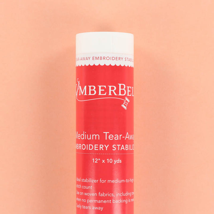 Roll of Kimberbell Medium Tear-Away embroidery stabilizer on a peach background