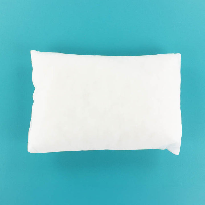 White Kimberbell Pillow Insert 12x18 on a teal background