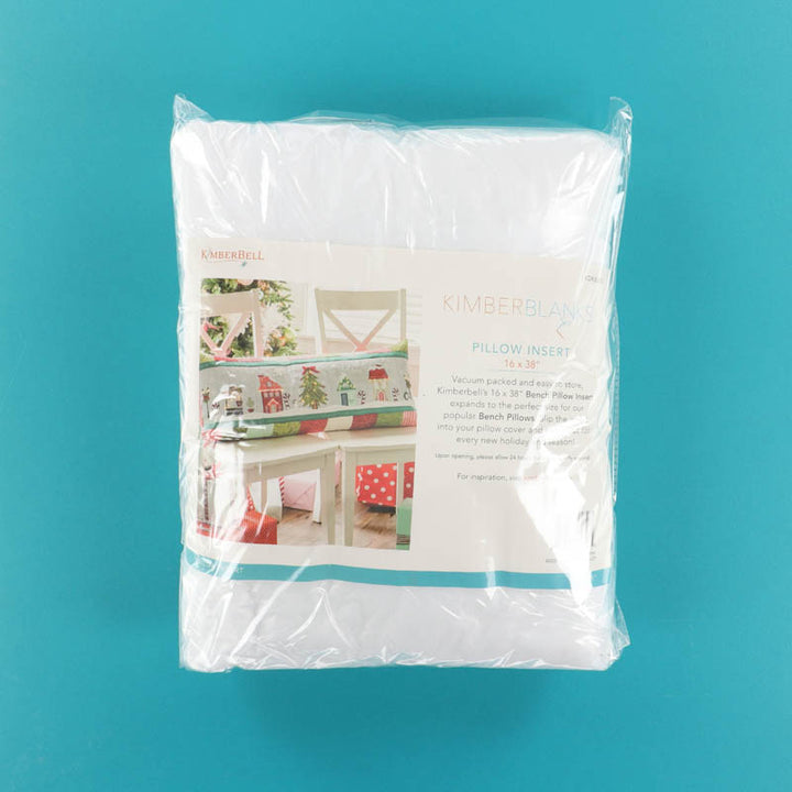 Packaged Kimberbell Pillow Insert on blue background