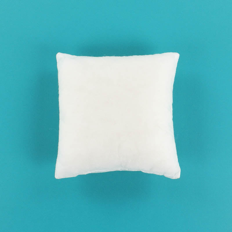 White pillow insert on a teal background