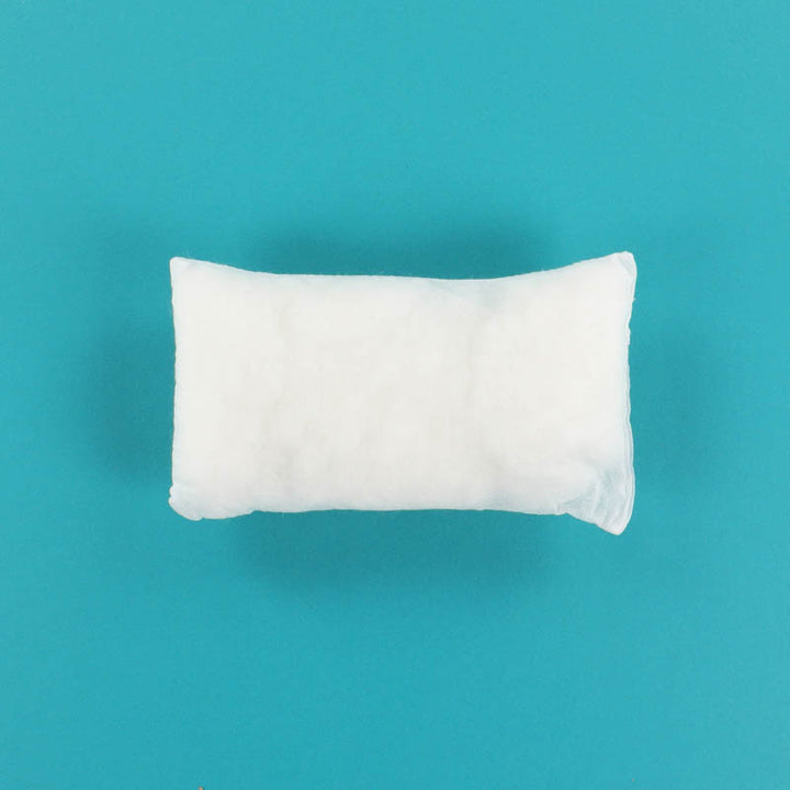 White Kimberbell Pillow Insert 9x5 on a teal background