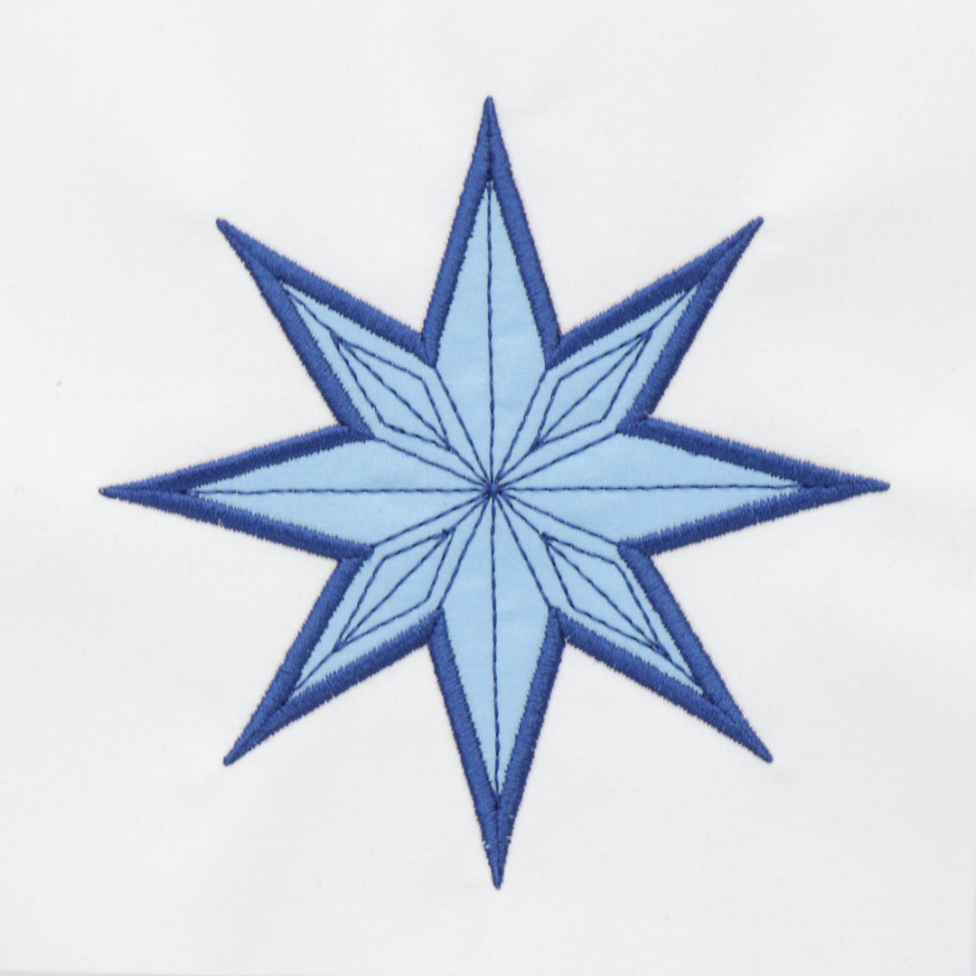 Blue snowflake applique on a white background