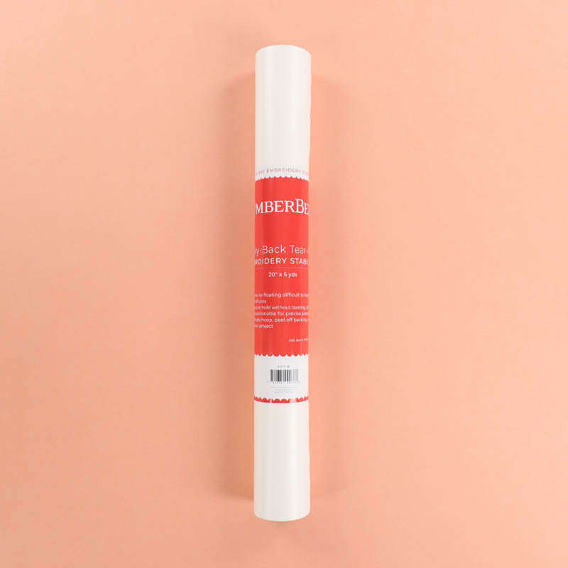 Roll of embroidery stabilizer with a red label on a peach background