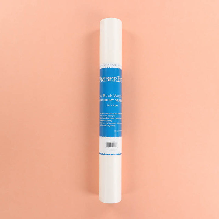 Roll of Kimberbell Sticky-Back Wash-Away on a peach background