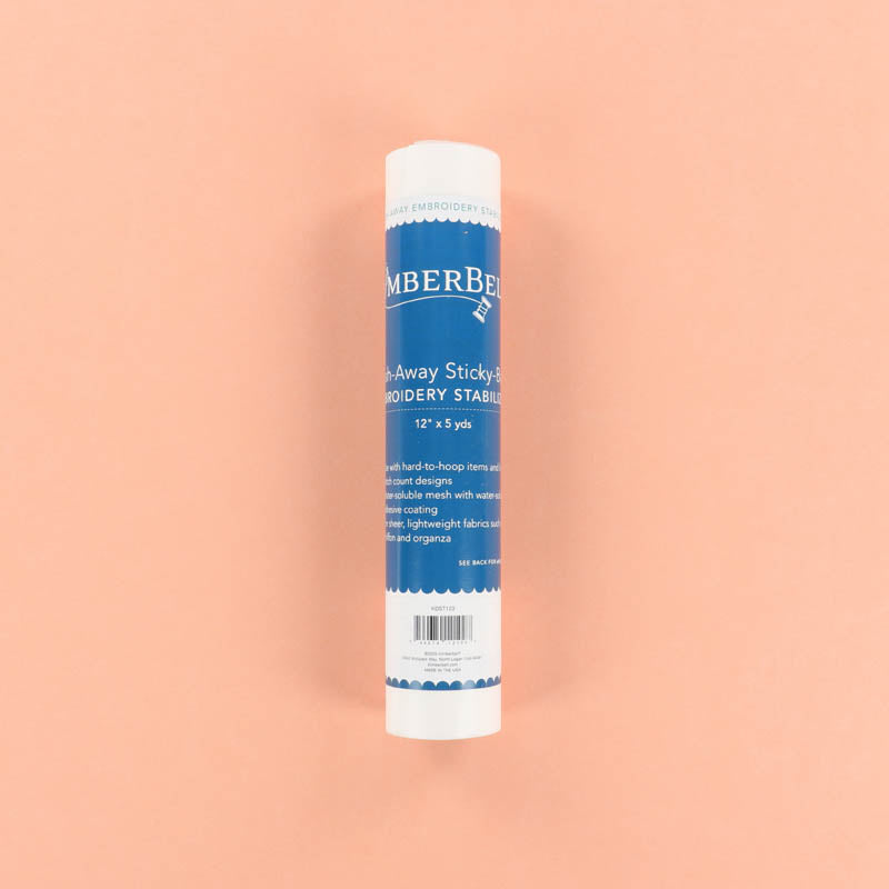 Roll of Kimberbell Sticky-Back Wash-Away Stabilizer on a peach background
