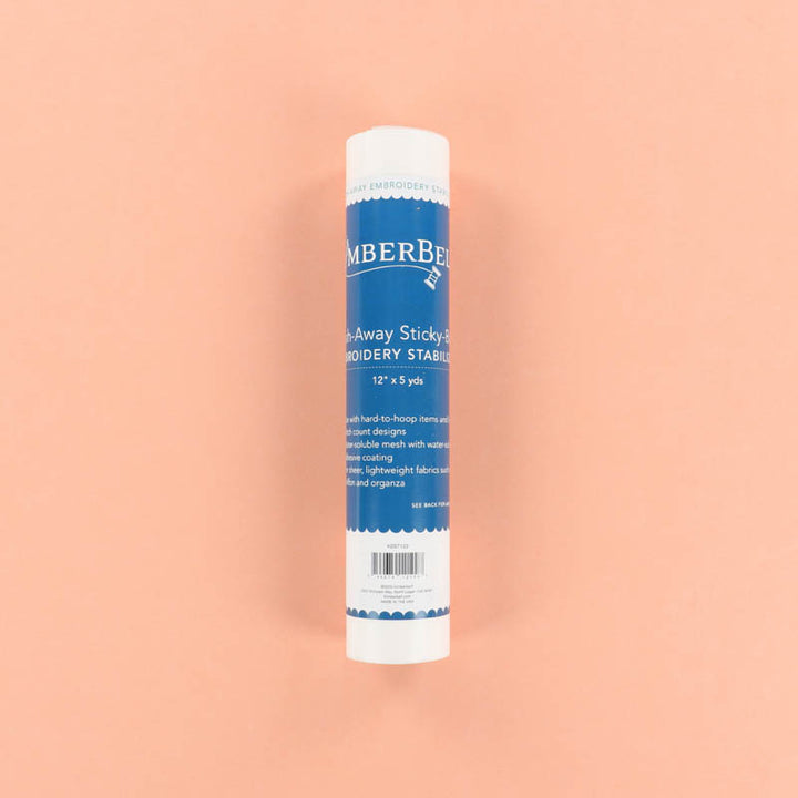 Roll of Kimberbell Sticky-Back Wash-Away Stabilizer on a peach background