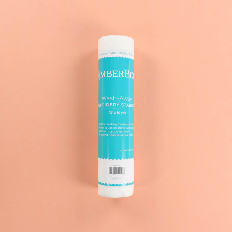 Roll of Kimberbell Wash-Away stabilizer on a peach background