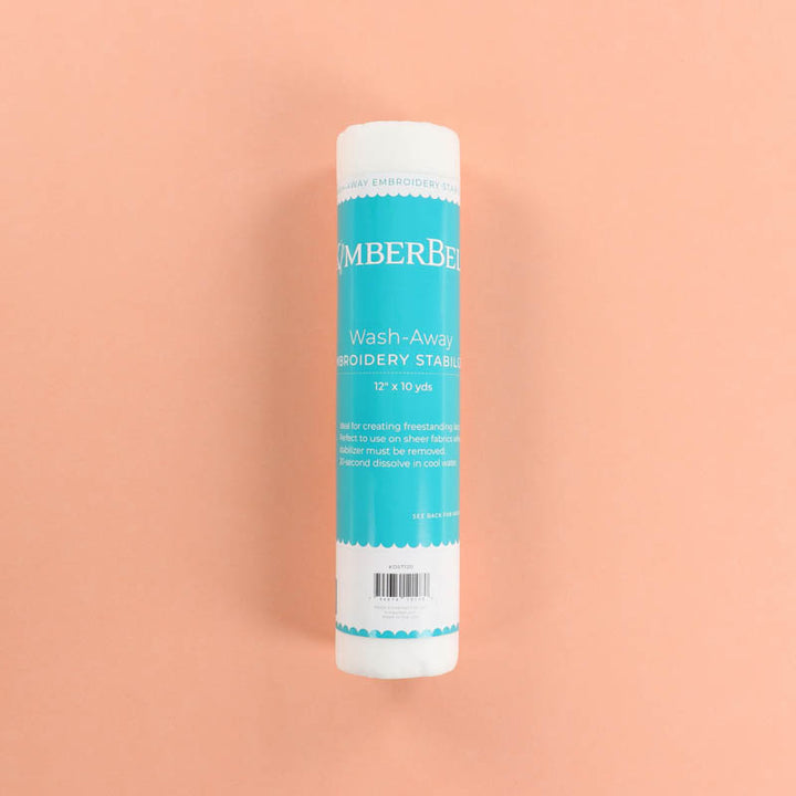 Roll of Kimberbell Wash-Away stabilizer on a peach background