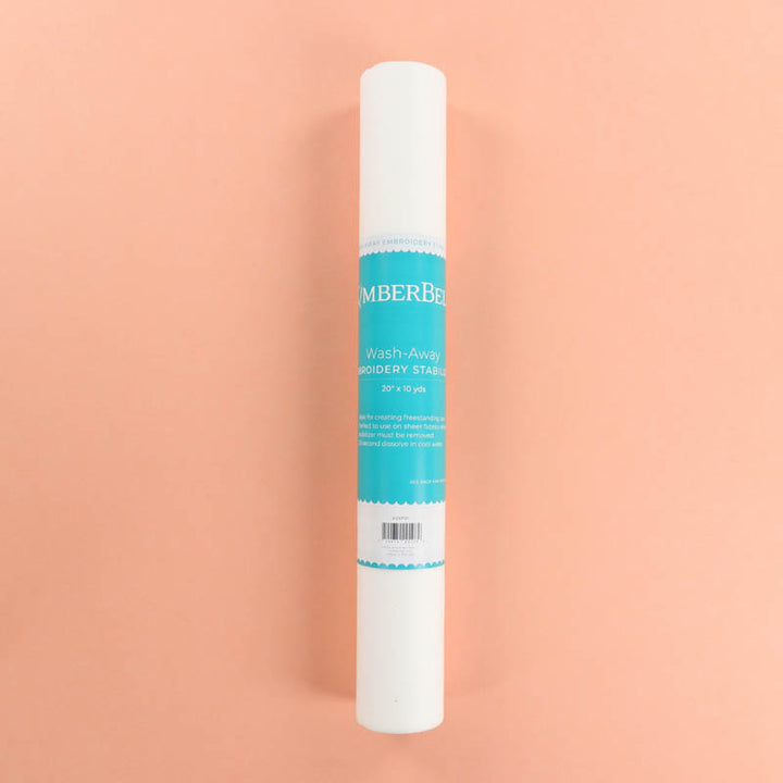 Roll of Kimberbell Wash-Away Stabilizer on a peach background