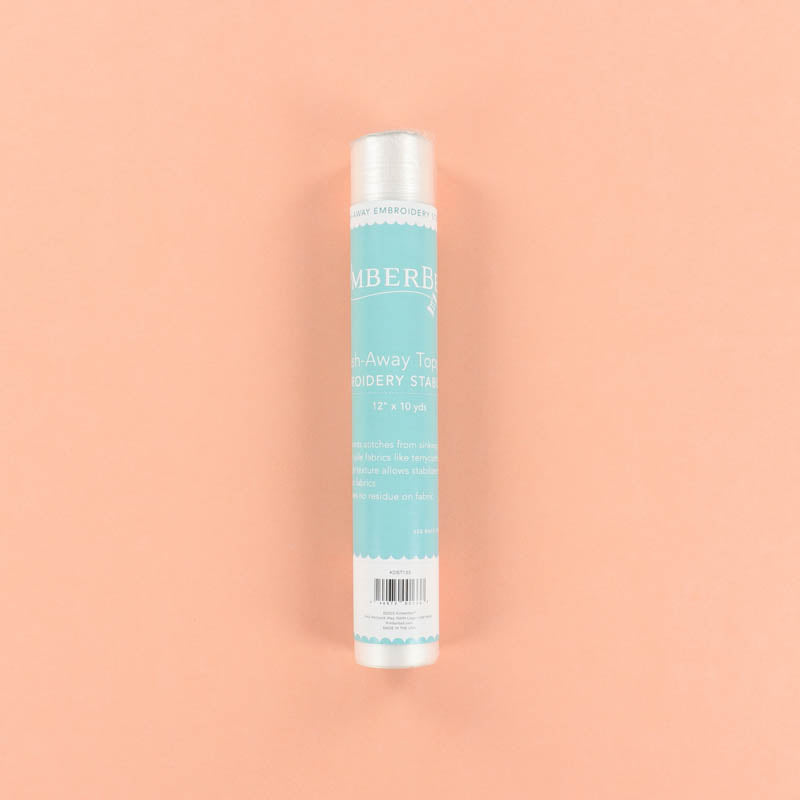 Roll of blue Wash-Away Topping on a peach background