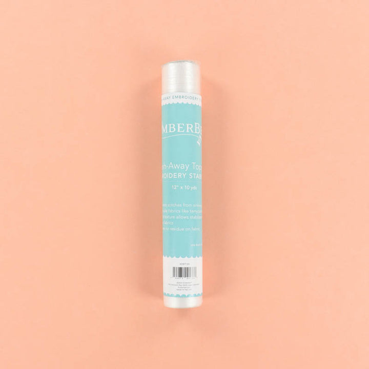 Roll of blue Wash-Away Topping on a peach background